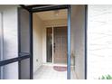 Covered porch with tiled flooring and a glass paneled front door at 5688 Lake Vista Ct # 31, Sarasota, FL 34233