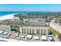 Stunning aerial view of the beachfront condo community, with expansive white sand beaches and turquoise ocean waters at 5780 Midnight Pass Rd # 210, Sarasota, FL 34242