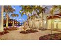 Picturesque backyard featuring a swimming pool, fountain, dining area, and lush landscaping, perfect for outdoor living at 601 Avenida De Mayo, Sarasota, FL 34242