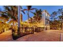 Charming two-story home with two-car garage, brick driveway and beautifully landscaped yard with mature palm trees at 601 Avenida De Mayo, Sarasota, FL 34242