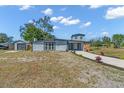 Single-story home with grey exterior, long driveway, and detached garage at 6512 Clemson St, Bradenton, FL 34207
