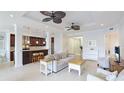 Spacious living room with tile floors, ceiling fans, and a combined kitchen view at 8043 St Simons St, Bradenton, FL 34201