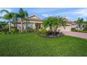 Charming home featuring a well-manicured lawn and lush tropical landscaping at 8294 Barton Farms Blvd, Sarasota, FL 34240