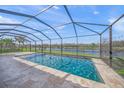 Screened pool with lake views and travertine tile at 8294 Barton Farms Blvd, Sarasota, FL 34240