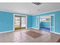 Bright living room featuring tile flooring, an open layout, and access to the backyard at 1004 12Th W Ave, Palmetto, FL 34221