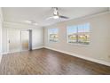 Bright living room with wood-look flooring, ceiling fan and sliding glass door to lanai at 1005 Villagio Cir # 106, Sarasota, FL 34237