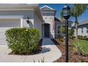 Welcoming front entrance with meticulously maintained landscaping, a decorative lamp post, and a clear, inviting pathway at 10914 Blue Magnolia Ln, Parrish, FL 34219