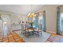 Charming dining room with a modern chandelier and access to the kitchen at 121 Tidy Island Blvd, Bradenton, FL 34210