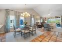 Bright dining area featuring a glass table, tile floors, and large windows at 121 Tidy Island Blvd, Bradenton, FL 34210