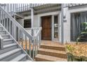 Townhome entrance featuring a stairway, door, and decorative stone landscaping at 1249 Dockside Pl # 110, Sarasota, FL 34242