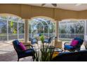 Inviting screened-in lanai with comfortable seating, creating the perfect outdoor living space around the spa at 12622 Safe Harbour Dr, Cortez, FL 34215