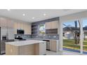 Stylish kitchen with stainless steel appliances, tile backsplash, and outdoor view at 1313 Kacerik St, North Port, FL 34288