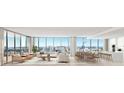 Spacious living room featuring floor-to-ceiling windows, modern furniture, and an open-concept layout with city views at 1703 Main St # 1205, Sarasota, FL 34236
