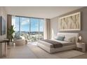 Serene bedroom boasts a bright view from the large windows, complemented by a modern design and decor at 1703 Main St # 1205, Sarasota, FL 34236
