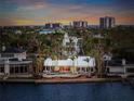 Waterfront home featuring a private pool, outdoor seating area, and stunning sunset views at 204 N Washington Dr, Sarasota, FL 34236