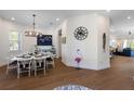 Elegant dining room with modern chandelier, stylish flooring and view to the living room at 211 81St St # B, Holmes Beach, FL 34217