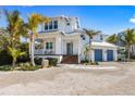 Stunning two-story home boasting lush landscaping, covered porch and two-car garage at 211 81St St # B, Holmes Beach, FL 34217