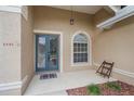 A close up of the front door with a gray frame and a window to the side at 2260 Island Creek Rd, Sarasota, FL 34240