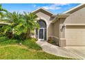 Inviting front entrance with mature landscaping and an arched entry door at 3007 Goodwater St, Sarasota, FL 34231