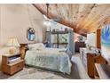 Cozy main bedroom with wood-clad vaulted ceiling, balcony access, and neutral decor at 3073 Willow Grn # 36, Sarasota, FL 34235