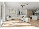 Spacious living room with a large sectional sofa and hardwood floors at 3319 S Osprey Ave, Sarasota, FL 34239