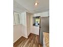 View of updated kitchen with stainless steel appliances, granite countertops, and modern wood flooring at 3987 Maceachen Blvd # 132, Sarasota, FL 34233