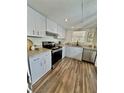 Updated kitchen with stainless steel appliances, granite countertops, and stylish wood flooring at 3987 Maceachen Blvd # 132, Sarasota, FL 34233