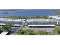 Low-rise condominium complex with carports, lush landscaping, and stunning water views at 4734 Independence Dr # 4734, Bradenton, FL 34210