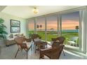 Inviting sun room with wicker furniture and sliding glass doors offering panoramic views of the water at 4734 Independence Dr # 4734, Bradenton, FL 34210