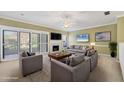 Inviting living room with comfortable seating, a fireplace, and sliding glass doors that offer natural light and outdoor views at 4920 Kestral Park Cir # 11, Sarasota, FL 34231