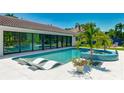 Stunning backyard showcasing a sparkling pool, a spa, stylish lounge chairs, and sleek, modern architecture at 526 Bird Key Dr, Sarasota, FL 34236