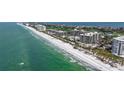 Exclusive condos on a white sand beach offering sparkling emerald water and mature tropical landscaping at 535 Sanctuary Dr # A202, Longboat Key, FL 34228