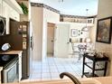 Bright kitchen featuring white tile floors and appliances and an adjacent breakfast nook at 5712 Cottonwood St, Bradenton, FL 34203