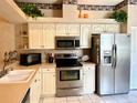 Well-equipped kitchen with stainless steel appliances, white cabinetry, and a practical layout at 5712 Cottonwood St, Bradenton, FL 34203