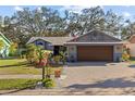 Charming single-story home with a two-car garage and large brick driveway at 604 68Th Avenue W Dr, Bradenton, FL 34207