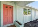 Close up showcasing the home's colorful front door, window, and brick accents, creating a welcoming entrance at 7807 24Th W Ave, Bradenton, FL 34209