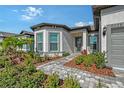 Close up view of the front entrance with stone walkway and garden at 9028 Sunray Cv, Parrish, FL 34219