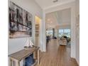 Open-concept floor plan with wood floors, views into the living and dining areas at 9028 Sunray Cv, Parrish, FL 34219
