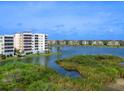 Scenic water view showcasing a condo building with balconies and beautiful surroundings at 10520 Boardwalk Loop # 205, Lakewood Ranch, FL 34202