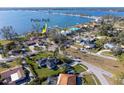 Aerial view of a coastal community featuring homes near a public park along the water, under a bright blue sky at 1103 Palma Sola Blvd, Bradenton, FL 34209
