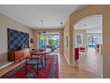 Open dining area with modern decor, hardwood floors, and a view of the pool area at 11910 Soft Rush Ter, Lakewood Ranch, FL 34202