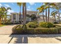 Beautiful home featuring lush landscaping, a charming entryway, and a grand three-car garage at 121 N Boulevard Of Presidents, Sarasota, FL 34236