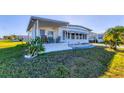 Cozy single-story home with a covered porch, green lawn, and a cactus garden, offering a relaxed outdoor living space at 1210 44Th Avenue E Dr, Ellenton, FL 34222