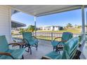 Inviting covered porch with comfortable seating, ideal for relaxing and enjoying neighborhood views at 1210 44Th Avenue E Dr, Ellenton, FL 34222