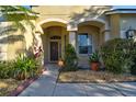 Inviting front entryway with arched alcove, neat landscaping, and a Vivint security system at 12286 23Rd E St, Parrish, FL 34219