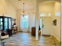 Bright living room featuring wood-look tile flooring, chandelier and arched doorway at 12286 23Rd E St, Parrish, FL 34219