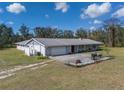An aerial view showcasing the home's private yard, back patio, long driveway, and proximity to nearby green space at 1510 Lena Ln, Sarasota, FL 34240