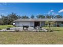 A back patio with a table, chairs, and a grill, perfect for outdoor entertaining at 1510 Lena Ln, Sarasota, FL 34240