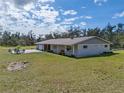Sprawling property featuring a well-maintained yard and charming single-story home with outdoor patio at 1510 Lena Ln, Sarasota, FL 34240