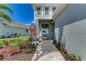 Landscaped entryway with a charming walkway leading to a welcoming front porch at 260 Van Gogh Cv, Bradenton, FL 34212